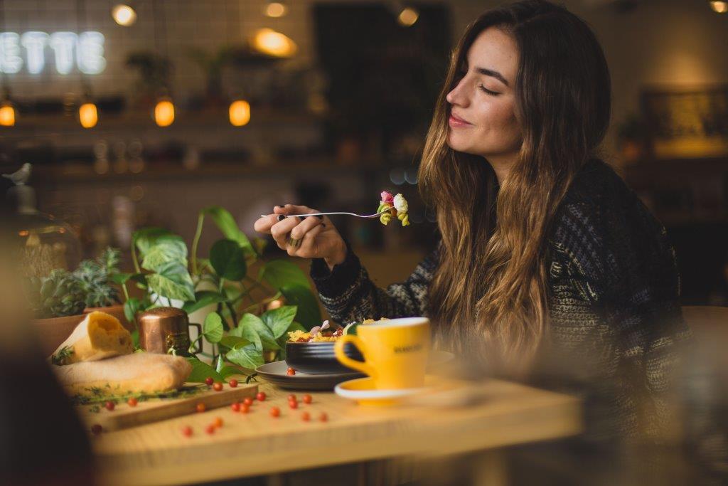 Woman Eating Slowly at a Table
